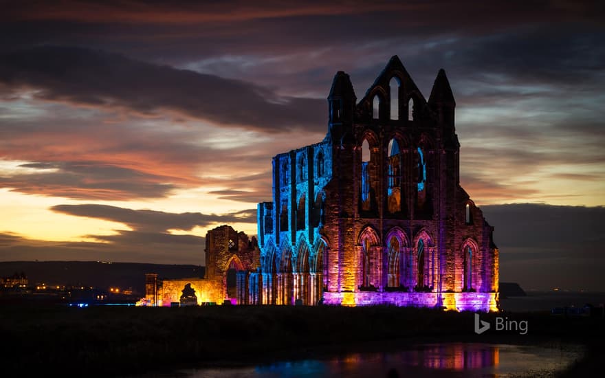 Whitby Abbey illuminated with coloured floodlights in North Yorkshire